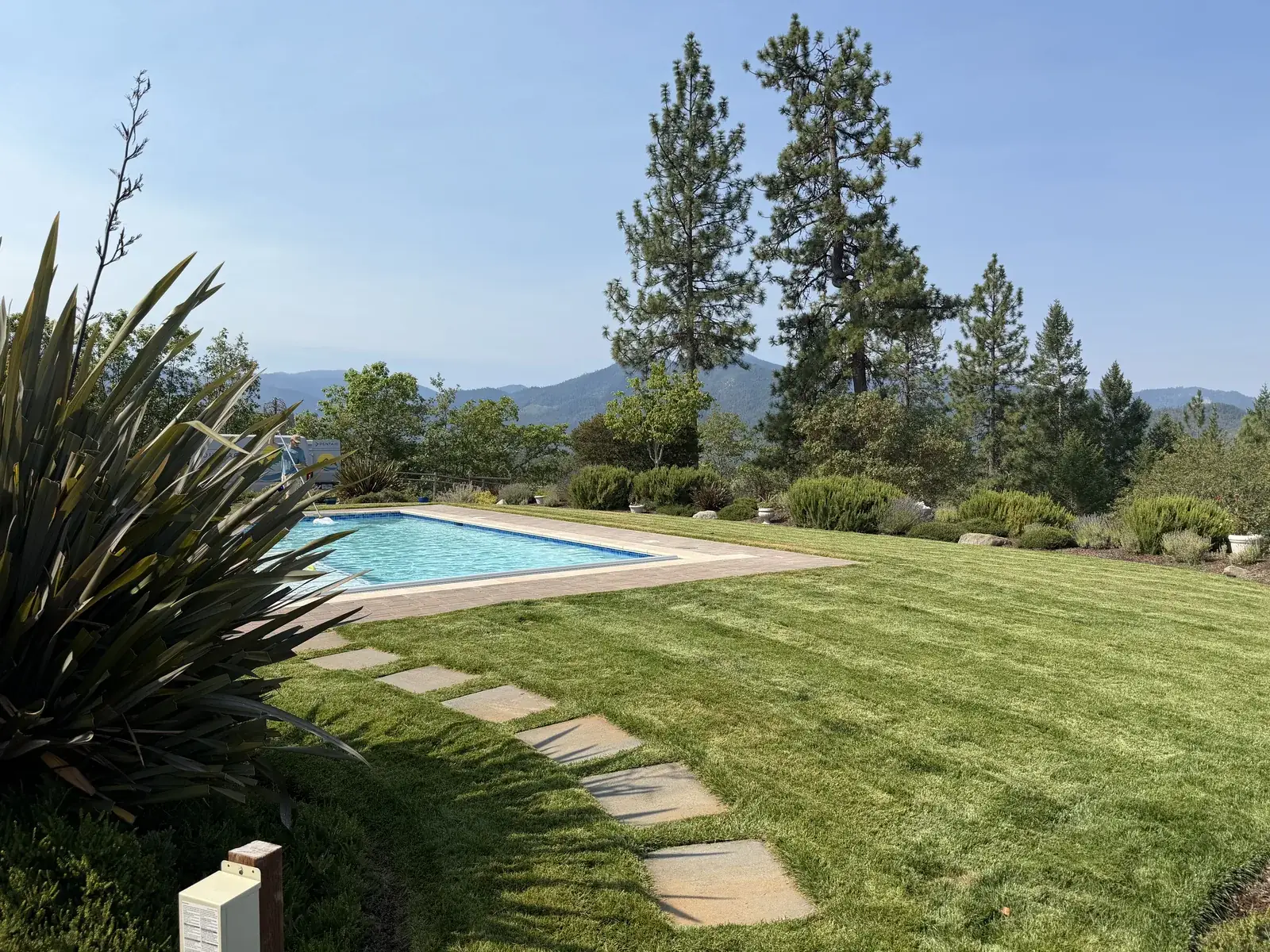 Lawn, stepping stone path and shrub beds maintained by Hilltop Landscaping on a Southern Oregon property